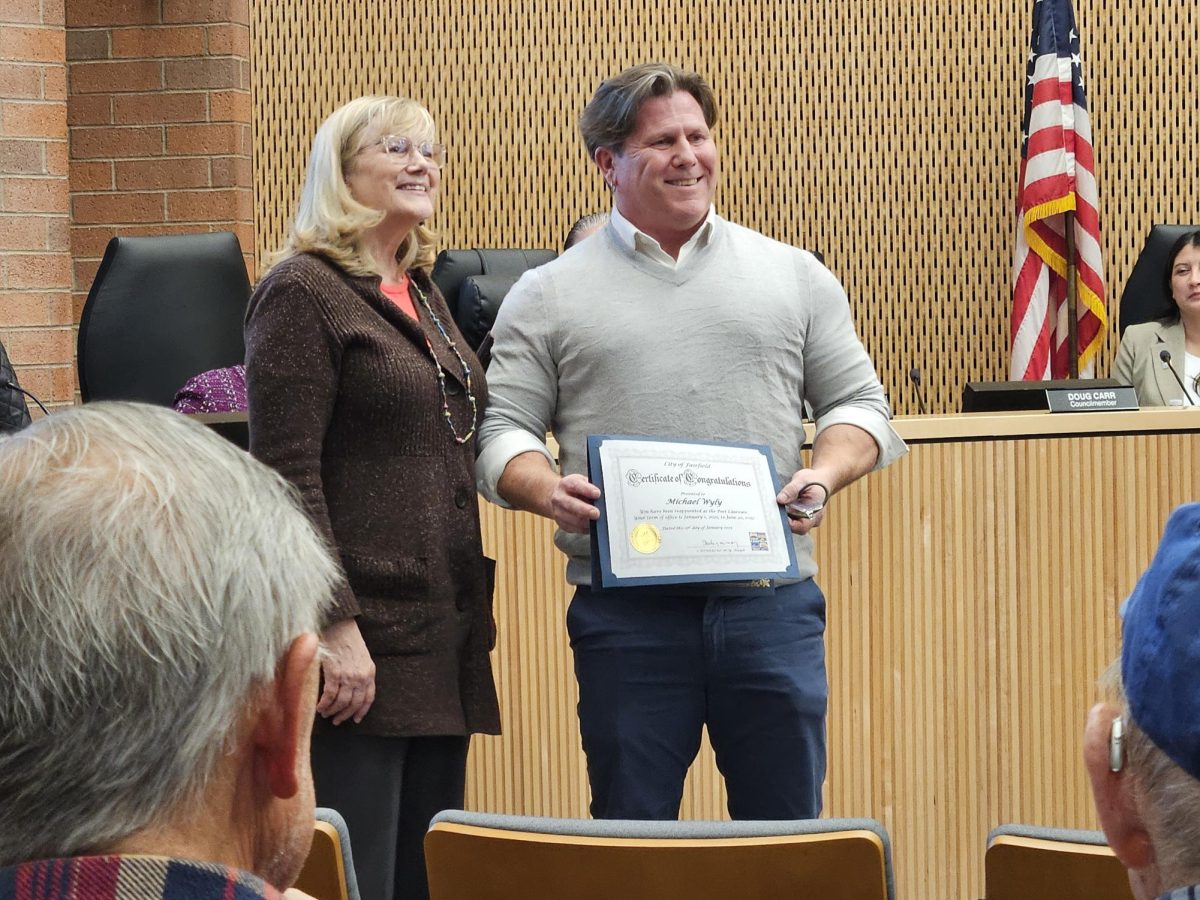 Fairfield City Clerk Karen Rees presenting Michael Wyly with his Poet Laureate proclamation.