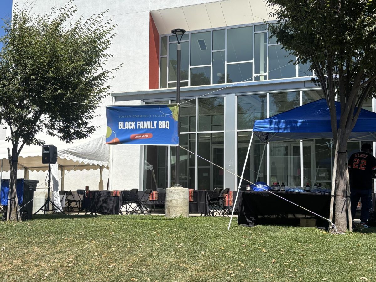 The DJ playing old school music in front of the Solano College Theatre and the Solano families.