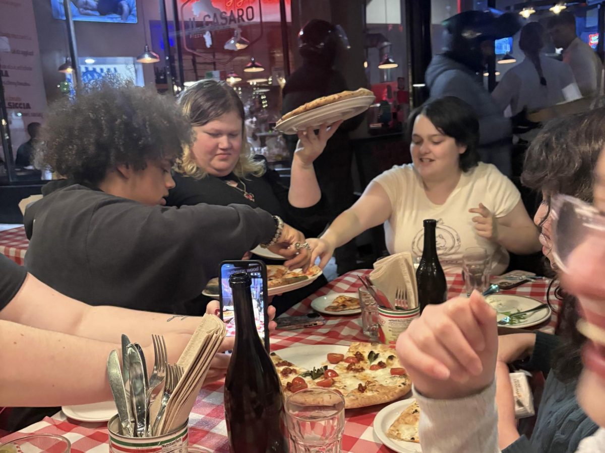 (Left to right) Sports Editor Elijah Reed, Reporter Blair Provencal, and Politics Editor Makenna Reese juggling pizza's on March 6, 2026.
