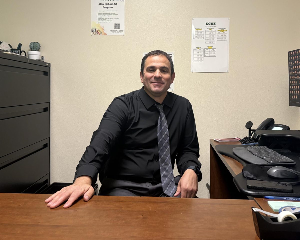 John Pizzo sits and smiles in his office.