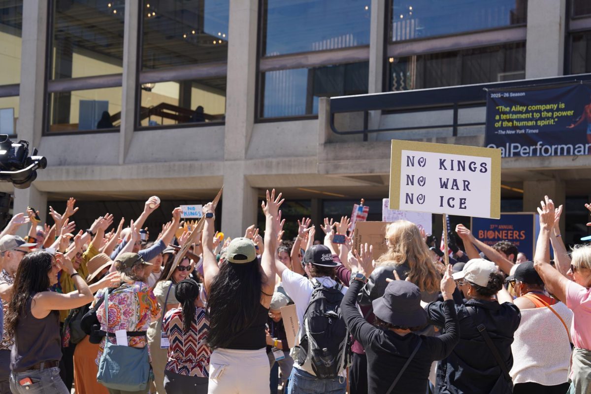 Hands reaching high while dancing on UC Berkeley campus, March 28, 2026.