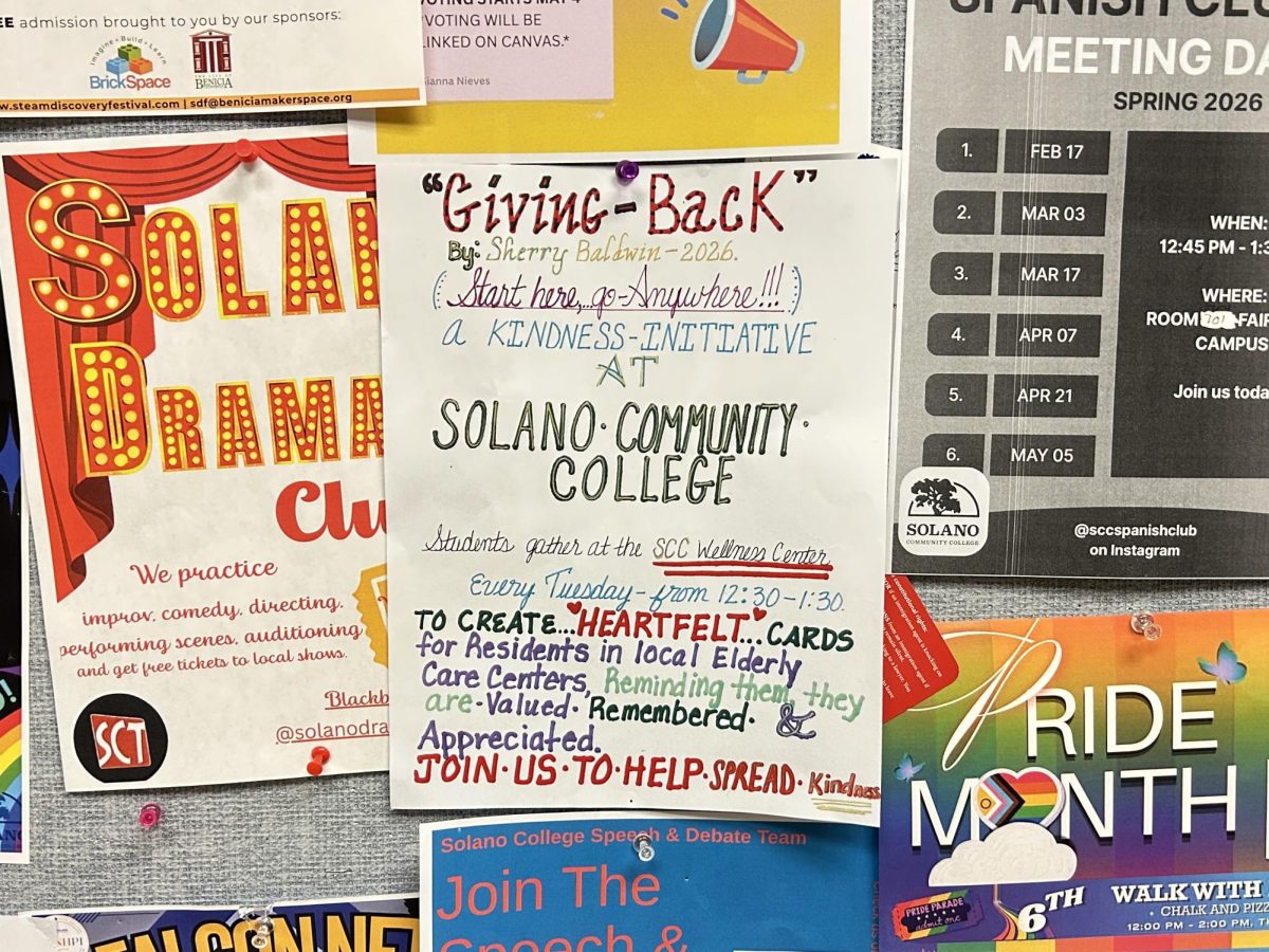 "Giving Back" promotional poster on the poster board in the 700 building, April 27, 2026.